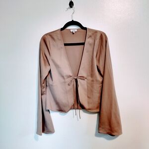 Tobi light brown long sleeve cover up top with tie in the front.  Sleeves flare